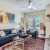 a living room with a couch and a coffee table and a tv