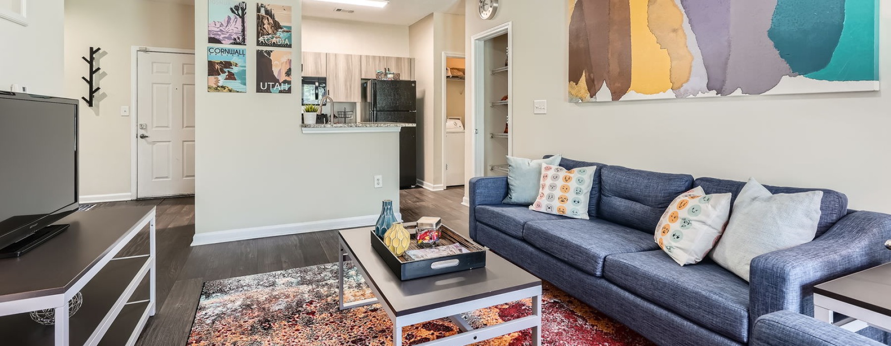 a living room with a couch, a tv and a coffee table