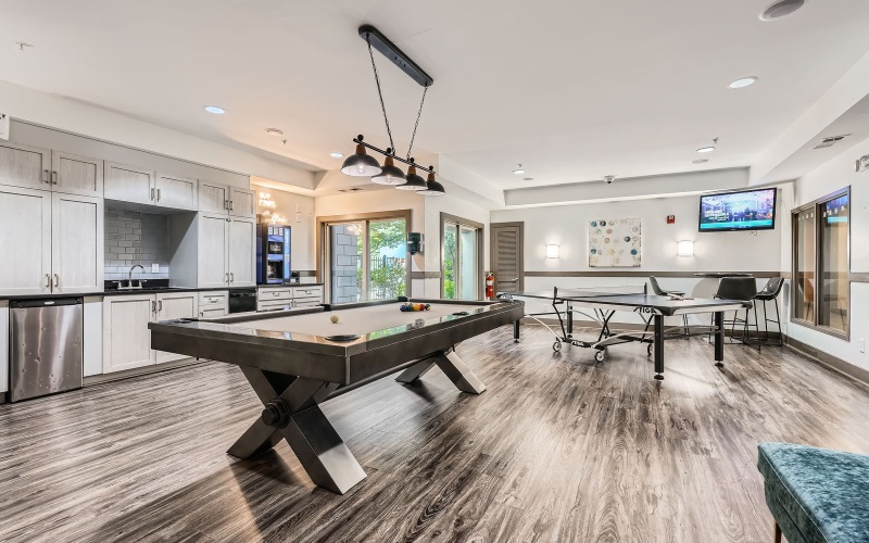 a pool table in a clubhouse room